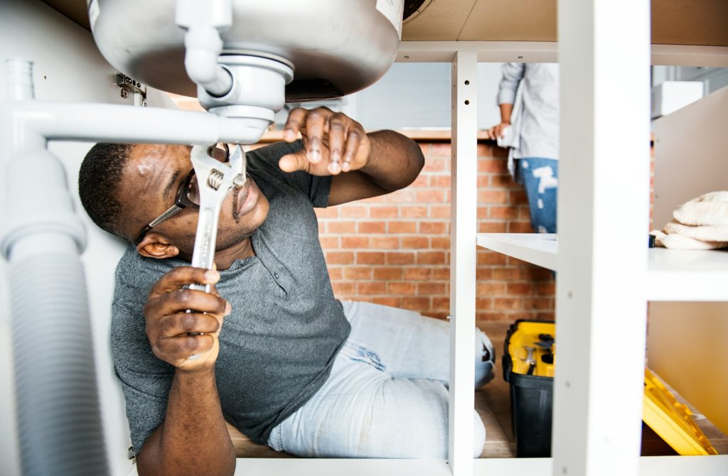 plumber fixing drain